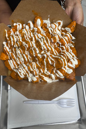 Butter Chicken Poutine at Habibz Corner — crispy fries topped with rich butter chicken sauce