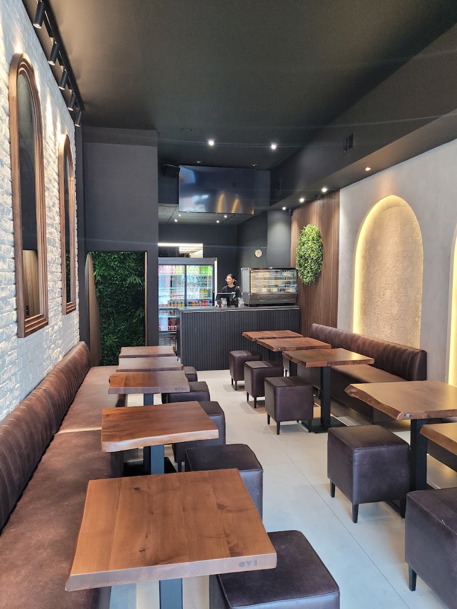 Inside Habibz Corner — modern interior with booths, counter seating, and warm decorative lighting